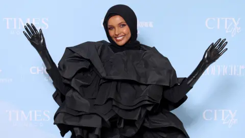 Daniele Venturelli/Getty Images Somali-American model Halima Aden waving at the World Influencers and Bloggers Awards in Cannes, France - Friday 26 May 2023