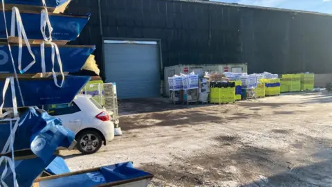 David Bradshaw Parcels stacked out a warehouse in Measham