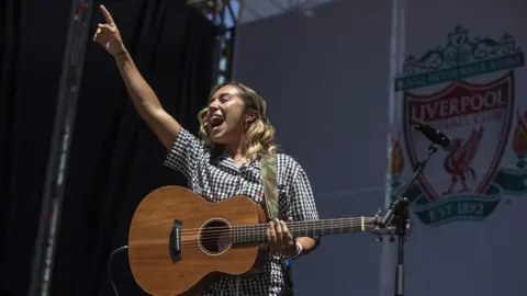 Getty Images Chelcee Grimes performing at the Liverpool fan zone before the men's Champions League final