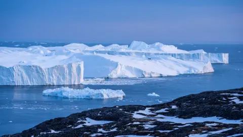 Thor Wegner/DeFodi Images via Getty Images Icebergs, calved from the Sermeq Kujalleq glacier, float in the Ilulissat Icefjord.