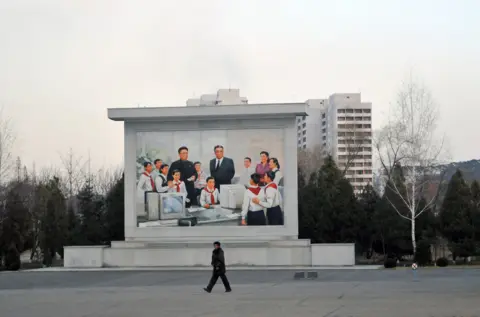 Getty Images A mural depicts Kim Il-sung and Kim Jong-il in a school IT class