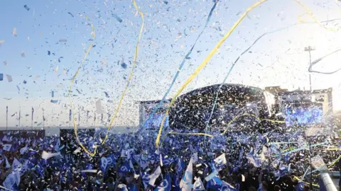 Eddie Mitchell Brighton & Hove Albion fans celebrate after being promoted