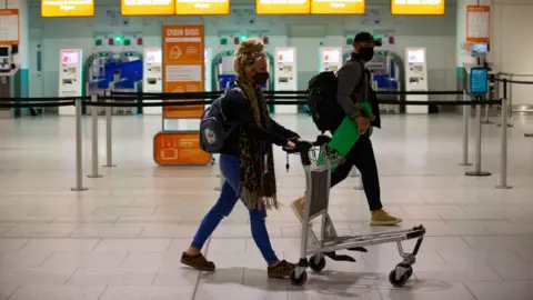 PA Media Passengers checking in at Gatwick