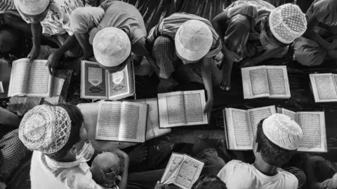 Getty Images Rohingya refugees study the Koran in Cox's Bazar, Bangladesh