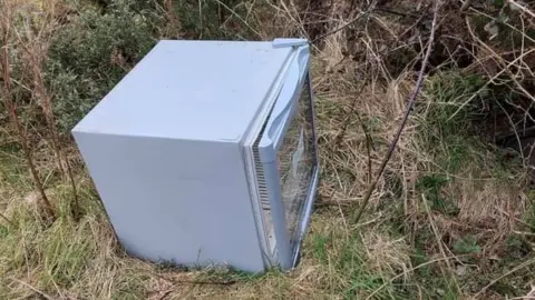 BALLAUGH COMMISSIONERS Fridge discarded in the countryside at Ballaugh