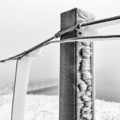 Mike Bentley Ice on a fence and post on the Pennine Way, Saddleworth Moor.