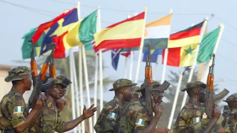 AFP Nigerian soldiers dance with their rifles around flags at the closing ceremony of joint military exercises in Benin to strengthen the military capabilities of West African countries - archive shot from 2004