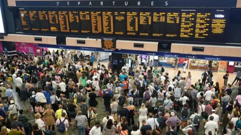 PA Media passengers at Euston station in London following train cancellations