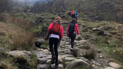 Kara, her sister Isobel and dad Stephen climbing Scafell pike