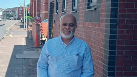 man standing outside mosque