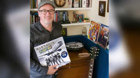 Colin Price Colin Price holding an Iron Maiden LP