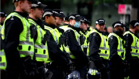 PA Media Line of police officers at George Square