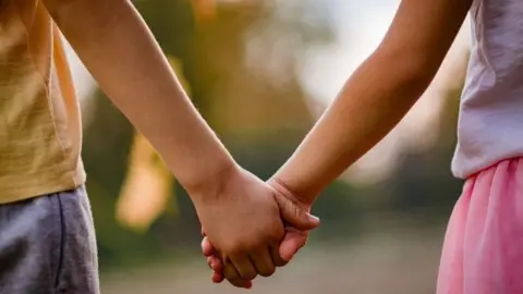 Getty Images Children holding hands