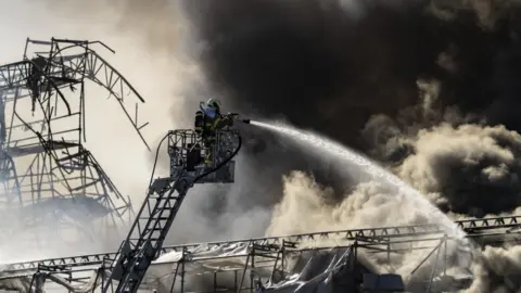  EPA-EFE/REX/Shutterstock Smoke filled the air in the centre of Copenhagen and the fire was only declared under control on Tuesday afternoon