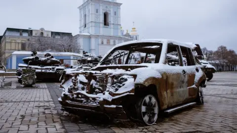 Getty Images Monastery of Saint Michel of Golden Domes covered with snow and view of the memorial of war with destroyed Russian military vehicles are seen in Kyiv