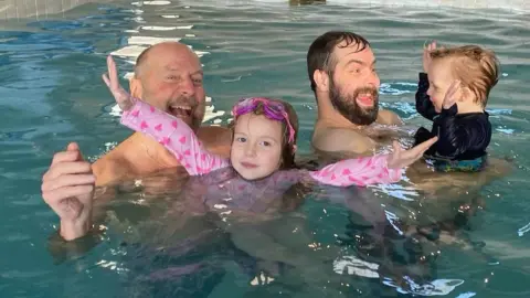 Ross Cunliffe Ross Cunliffe with his son and grandchildren in a swimming pool