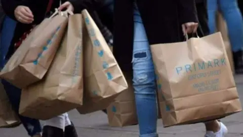 Getty Images Primark shoppers carrying bags