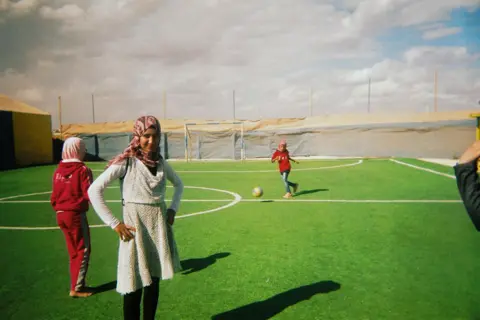 Maram Girls train on a football pitch