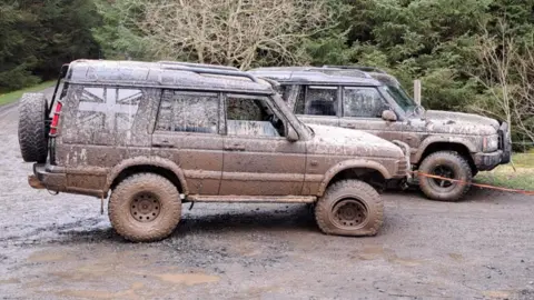 Northumbria Police Two mud covered Land Rover-type vehicles