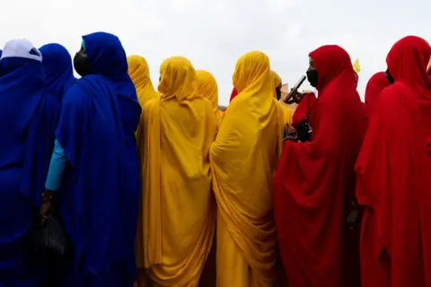 JORIS BOLOMEY/AFP Women wait for the arrival of Mahamat Idriss Déby Itno.