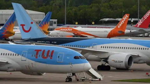 AFP Planes stand still at Manchester Airport