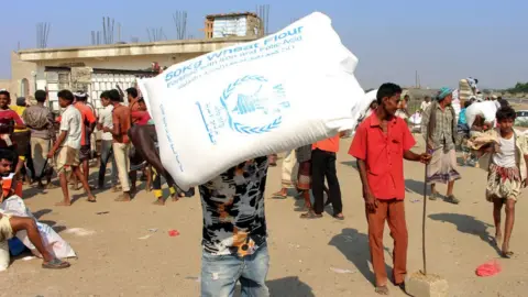 Getty Images Displaced Yemenis receive food aid