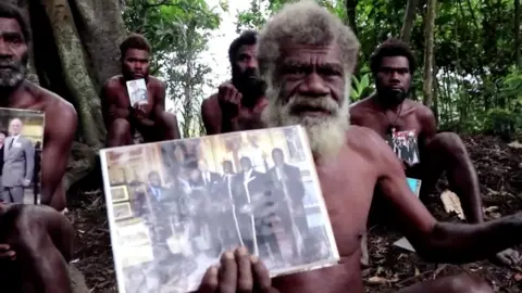 Reuters Ikunala village Chief Yapa holds photos of himself and four other local men with Britain"s Prince Philip, taken during their 2007 trip to England, as he sends their condolences after the prince passed away at age 99 on Friday, in Ikunala, Tanna island, Vanuatu April 11, 2021.