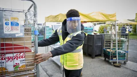 PA Media Marcus Rashford helps out at a food bank