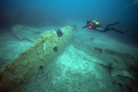 AFP A French military diver member of the FS Pluton M622 navy de-mining ship, swims above the wreck of an USAAF P-47 Thunderbolt (Warthog) US fighter plane