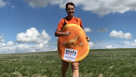 Sally Orange in an orange costume
