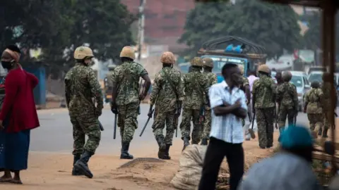 Getty Images Security force members on patrol in Kampala, Uganda - 14 January 2021