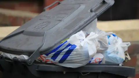 Getty Images Overflowing bin