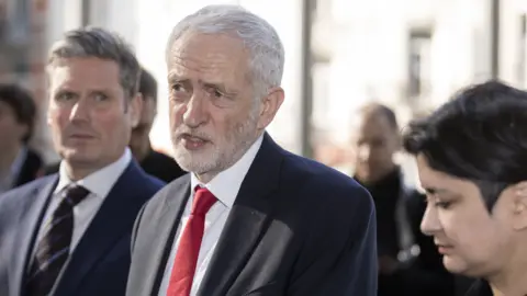 Getty Images Jeremy Corbyn (C) in Brussels, 21 Feb 19