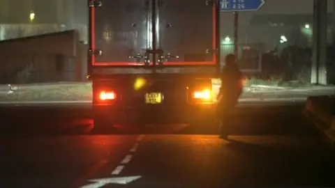 Migrant running towards truck