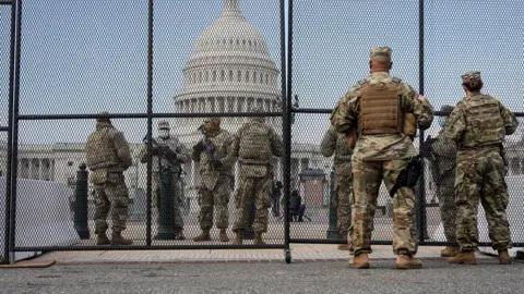 Reuters National Guard soldiers maintain a watch over the U.S. Capitol after the House of Representatives impeached U.S. President Donald Trump in Washington,