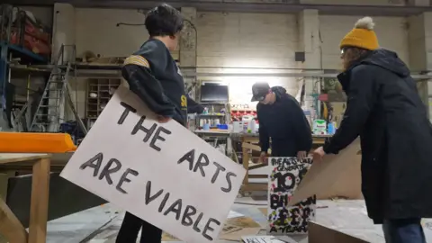 Gemma Dunne Gemma Dunne and others preparing placards for the March for the Arts