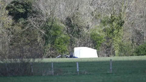 PA Media A police tent erected near the search
