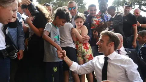 Reuters French President Emmanuel Macron visits the Benza district in Marseille, France, 28 June 2023