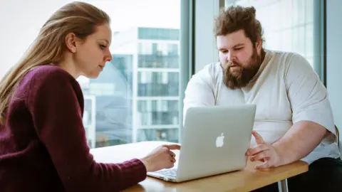 Auticon Auticon job coach Antonia Hatzfeldt and Auticon consultant Thomas Cowley