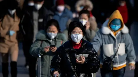 Getty Images Travellers in Beijing all wearing facemasks