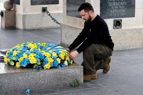 Wojtek Radwanski / AFP Ukrainian President Volodymyr Zelensky pays his respects at a wreath-laying ceremony at The Tomb of the Unknown Soldier in Warsaw, Poland, on 5 April 2023