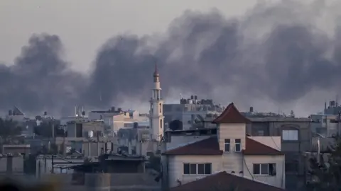 EPA Smoke rises following an Israeli air strike during a military operation in Khan Yunis, southern Gaza Strip, 1 March