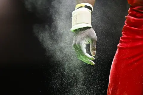 GABRIEL BOUYS/AFP The hands of Belgium's Noah Kuavita is seen before competing on the pommel horse during the Men's All-Around Finals plus qualification for Team and Individual Apparatus Finals event at the Artistic Gymnastics European Championships, in Rimini, Italy, April 24, 2024.