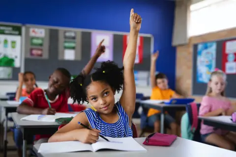 Getty Images Child with her hand up