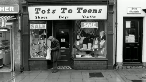 Malcolm Glover A man leaves the Tots to Teens shop in Pwllheli