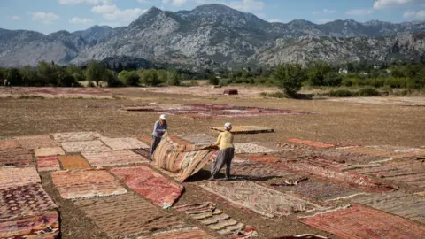 Getty Images Turkish carpet-makers dry out their wares