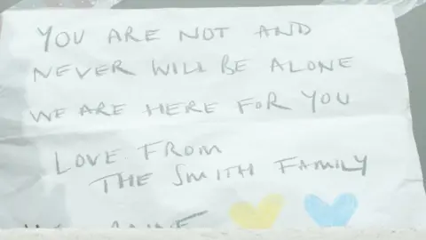 Tricia de Courcy Ling Sign stuck to a window in support of those in Ukraine