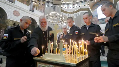 EPA Servicemen in St Petersburg light candles in memory of victims, 4 Jul 19