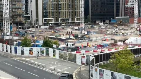 Image showing construction workers, equipment and structures at the development near Wembley Stadium.