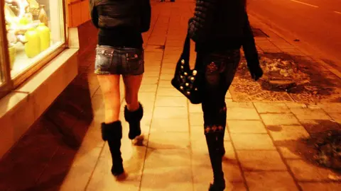 PA Women walking along street